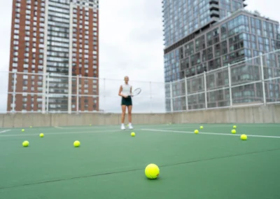 Tennis balls scattered on the tennis court.
