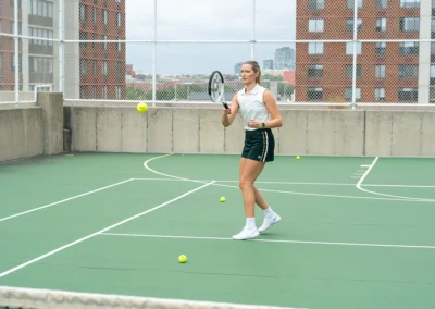 Woman playing tennis on a court.