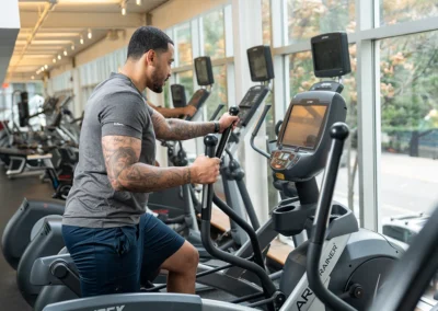 Trainer exercising on an elliptical machine.