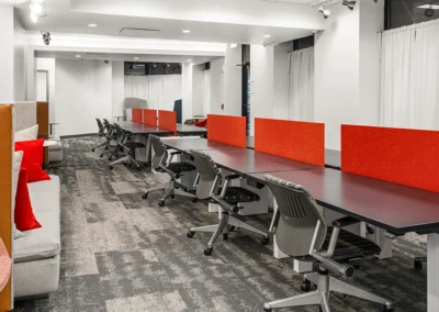 Co-working space with workstations and collaborative areas.