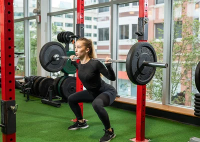 Woman performing a squat while holding weights.