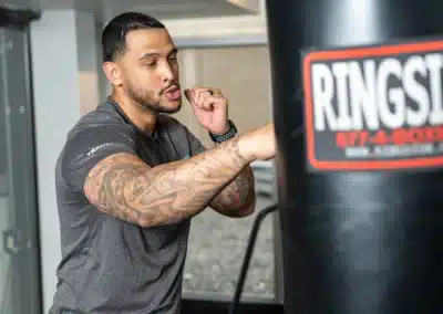 Boxer striking a punching bag during a workout.